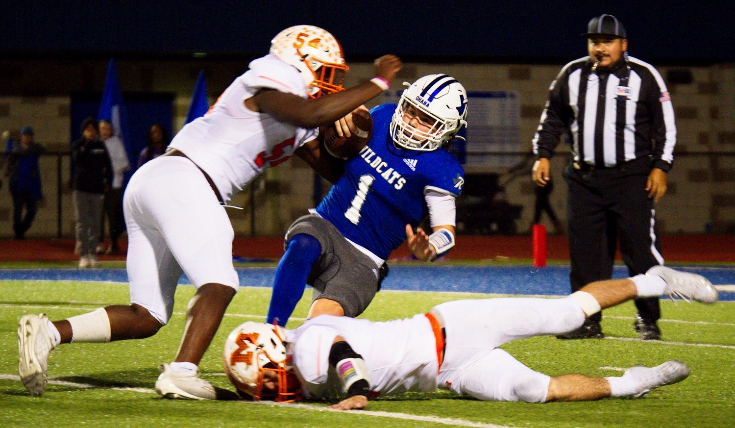 D.J. Newsome (54) and Coy Anderson sack the Wildcat quarterback for a loss in the fourth quarter. [See more of how Mineola reigned supreme.]